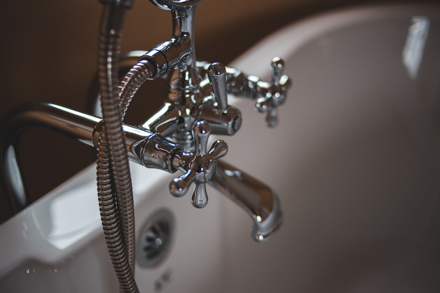 Polished chrome faucet running clear hot water